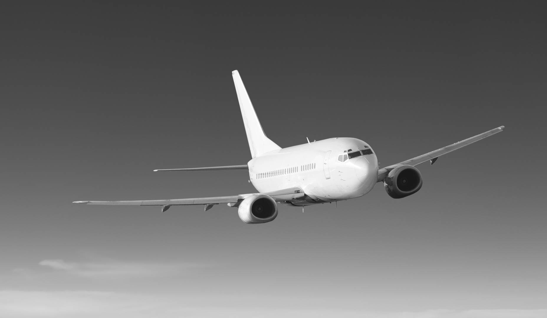 An jet flies against a cloudless sky.