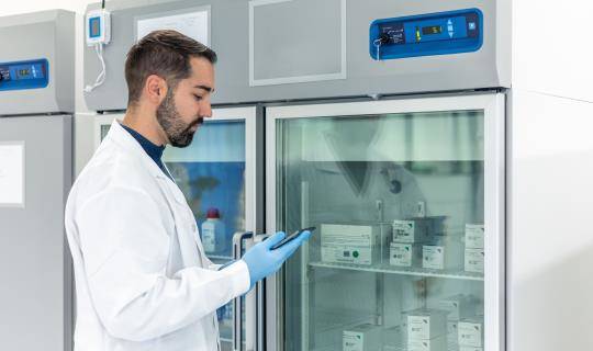 Scientist examines therapy from a clinical trial