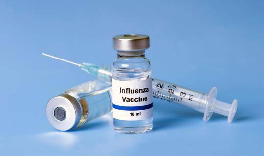 flu vaccine and syringe