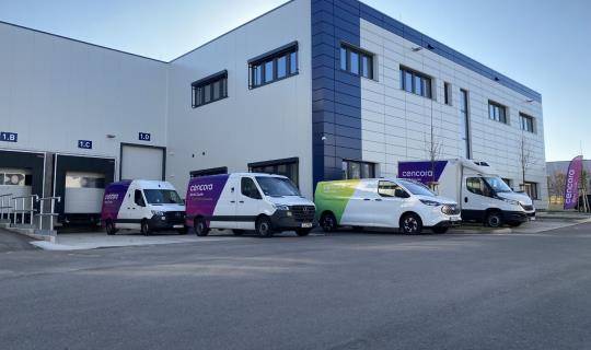 World Courier vans in front of new Stuttgart facility building
