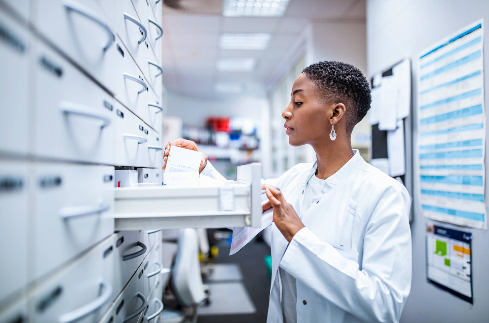Medical professional sorting through files and prescriptions