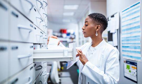 Medical professional sorting through files and prescriptions