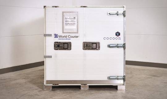 A cocoon shipping unit with the door sealed, viewed from the loading end.