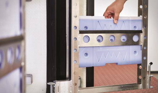 Someone loads a cooling gel pack into Cocoon's internal frame.