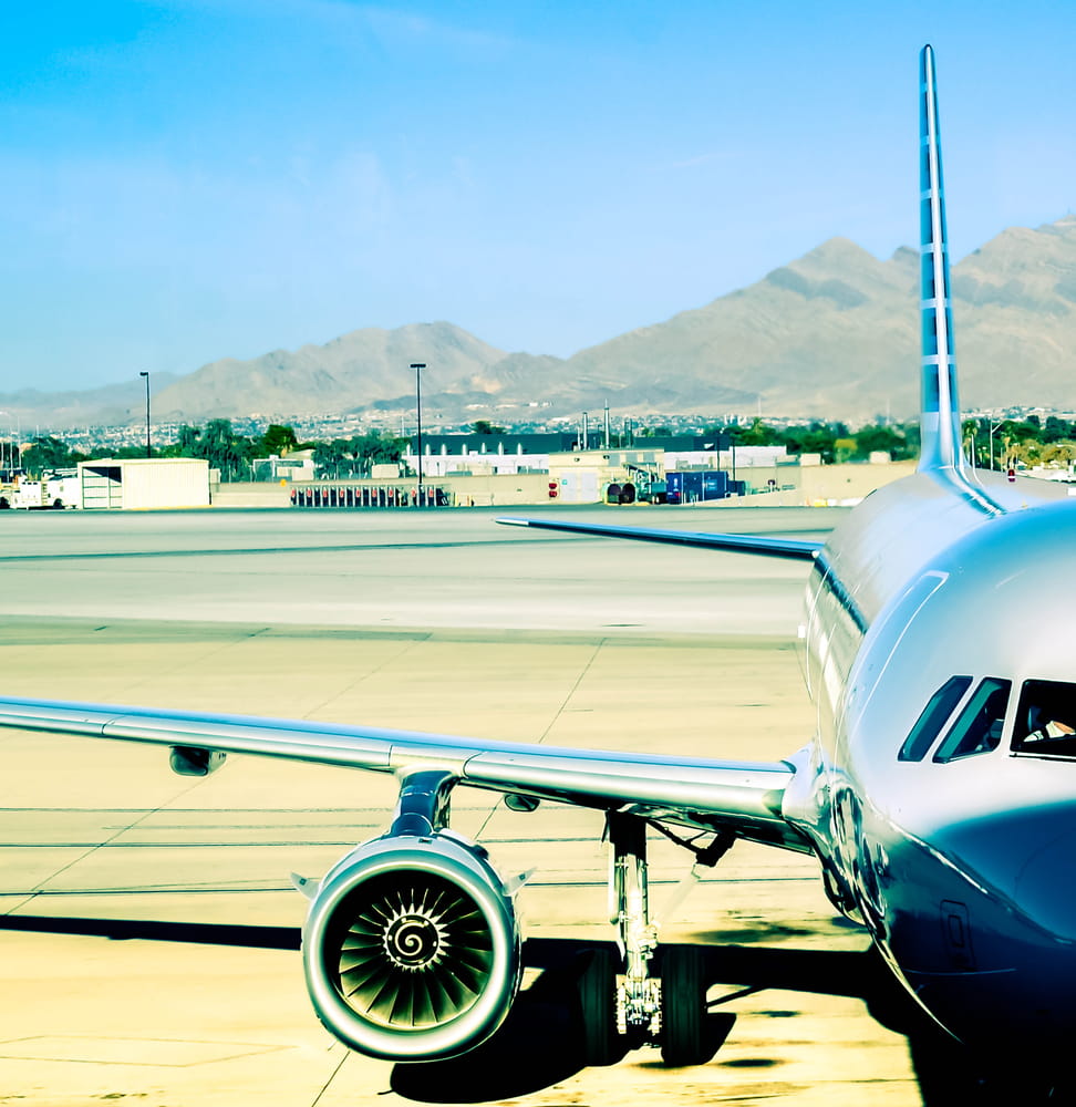 A closeup view of a jet plane sitting at a gate, ready to be loaded.