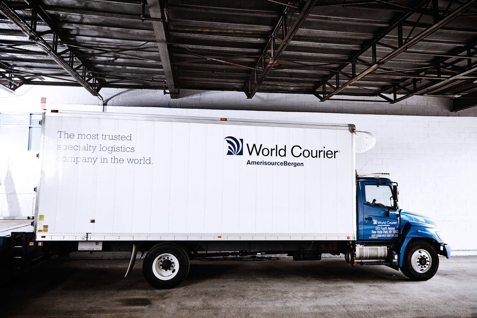 A large World Courier truck, or lorry, parked at a loading dock.